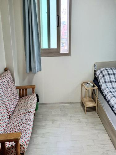 a room with a couch and a bed and a table at Wandonesia in Wando