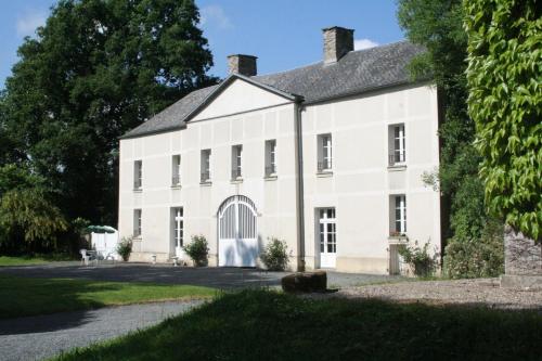 a large white house with a driveway at château de lamberville in Lamberville