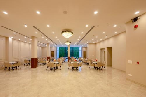 a large banquet hall with tables and chairs at Limewood Signature - Golf Course Extension Road in Gurgaon