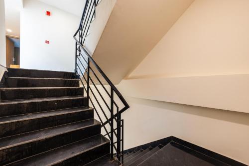 a staircase in a building with black steps at Limewood Signature - Golf Course Extension Road in Gurgaon
