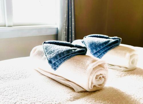 a pile of towels sitting on top of a bed at 298 Home in Christchurch