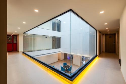 a large glass wall in a room with a chair at Limewood Signature - Golf Course Extension Road in Gurgaon