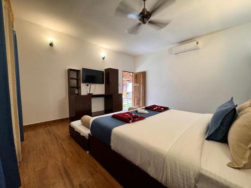 a hotel room with a bed and a ceiling fan at Lemon Grass Resort & Spa in Havelock Island