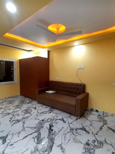 a living room with a couch and a marble floor at Hotel The Prince Palace Near Mahabodhi Temple - Wifi and Parking Facilities in Bodh Gaya