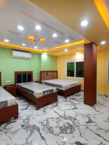 a room with three beds and a marble floor at Hotel The Prince Palace Near Mahabodhi Temple - Wifi and Parking Facilities in Bodh Gaya