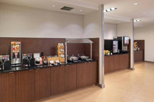 a lobby of a hotel with a counter and a kitchen at Fairfield Inn & Suites by Marriott Springfield Northampton/Amherst in Northampton