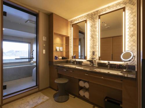 a bathroom with two sinks and a large mirror at Hotel Shion in Morioka