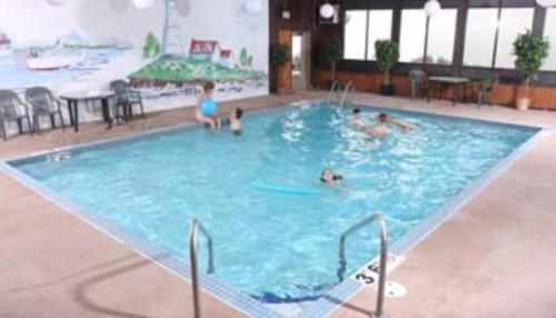 a group of people in a large swimming pool at Lighthouse Inn - Two Rivers in Two Rivers