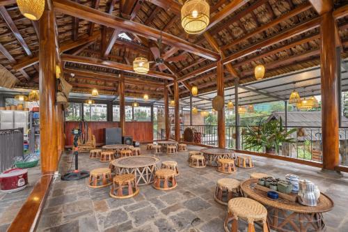 a large room with tables and chairs in a building at Villa Nhà Ba Gian Hoà Lạc in Nam Giao