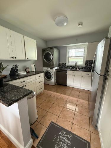 a kitchen with white cabinets and a refrigerator at Modern 3BR Spacious & Bright in Hoboken