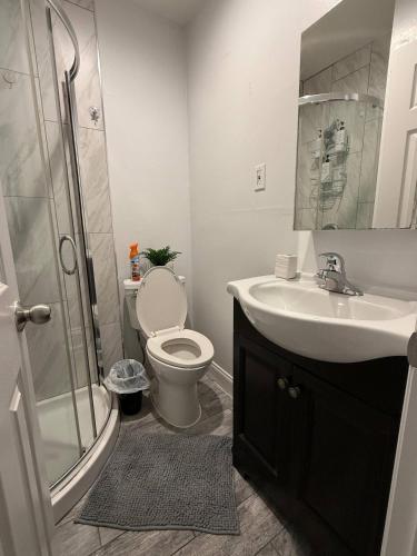 a bathroom with a toilet and a sink and a shower at Modern 3BR Spacious & Bright in Hoboken