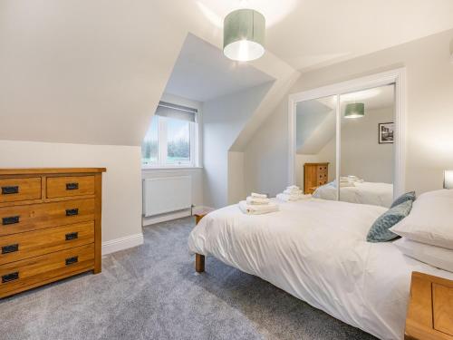 a bedroom with a bed and a large mirror at Fiadh Ruadh-Uk40008 in Gartmore