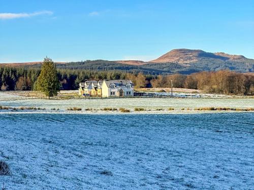 a house in the middle of a snow covered field at Fiadh Ruadh-Uk40008 in Gartmore
