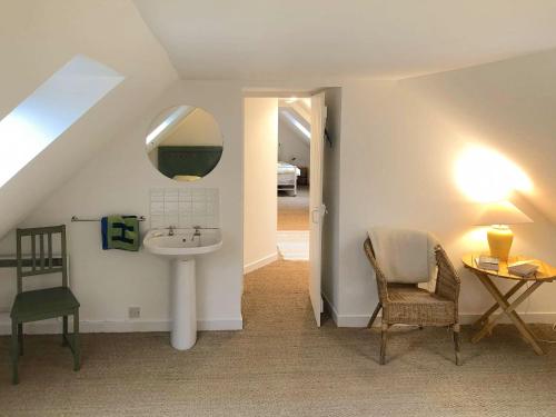 a bathroom with a sink and a mirror and a chair at Ledmore in Arle
