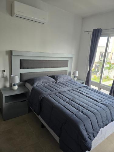 a bedroom with a large bed and a window at Casa EBaNa in El Jobo