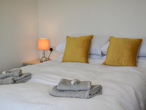 a white bed with towels and pillows on it at Seaview in Barvas