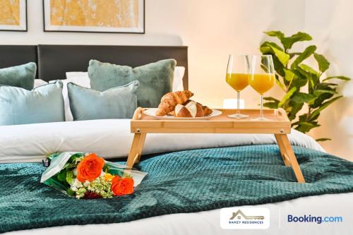 a tray of bread and two glasses of wine on a bed at 1 Bedroom Apartments By Ramzy Residences Short Lets & Serviced Accommodation In Kent With Free Wifi in Sevenoaks