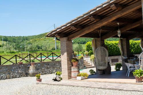 a pavilion with a table and chairs on a patio at La Locanda Dell'olmo in Orvieto
