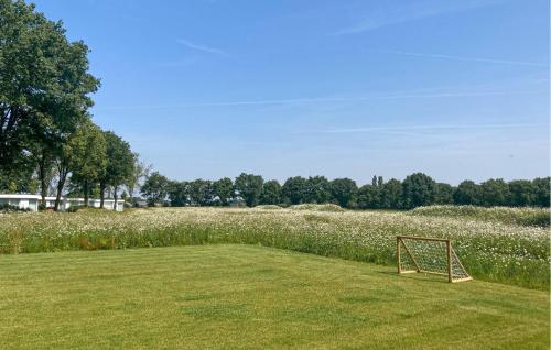a soccer goal sitting in the middle of a field at 2 Bedroom Stunning Home In Afferden in Afferden
