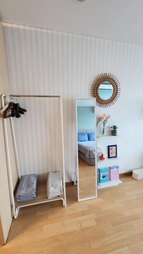 a bedroom with a mirror and a bed in it at Hongdae Guesthouse4 - 1min from Hongik Uni station Exit #1 in Seoul
