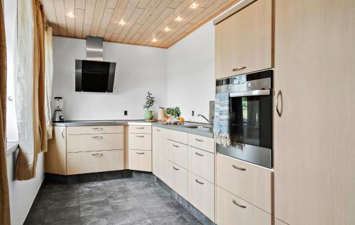 a kitchen with white cabinets and a sink at Stunning Home In Ribe With Wifi in Ribe