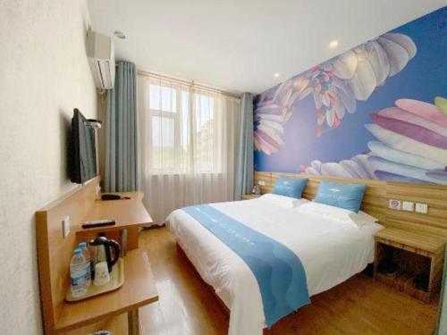 a bedroom with a bed with a fish painted on the wall at PAI Hotel Shijiazhuang Luquan Zoo in Shijiazhuang