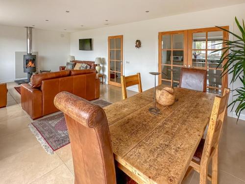 a dining room and living room with a wooden table at Lurach House - Ukc6791 in Port Appin
