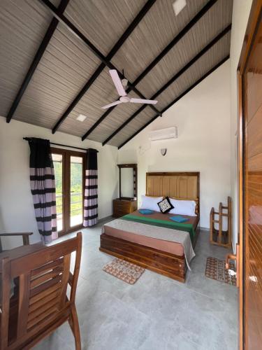 a bedroom with a bed and a ceiling fan at Royal Crown Residency Hotel in Talawatugoda