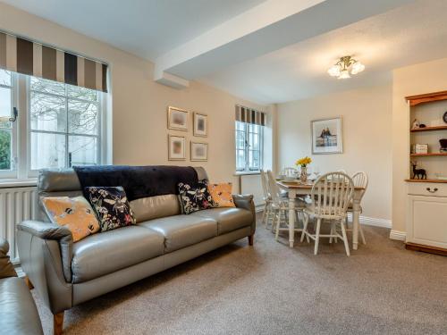 a living room with a couch and a table at Tennay Cottage in Wareham