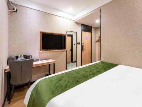 Ένα ή περισσότερα κρεβάτια σε δωμάτιο στο Shell Hotel Shandong Jinan Daming Lake