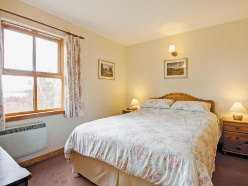a bedroom with a bed and a window at Moy in Taynish