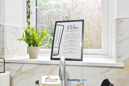 a kitchen window sill with a sign on a sink at 1 Bedroom Apartments By Ramzy Residences Short Lets & Serviced Accommodation In Kent With Free Wifi in Sevenoaks