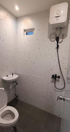 a bathroom with a toilet and a sink at Rumah Marianne in Sorong