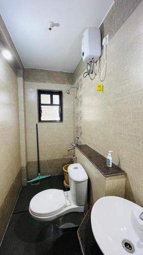 a bathroom with a toilet and a sink at Studio flats in Candolim in Candolim