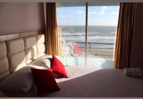 a bedroom with a bed with a view of the ocean at Hotel Sea Palace Ltd in Cox's Bazar