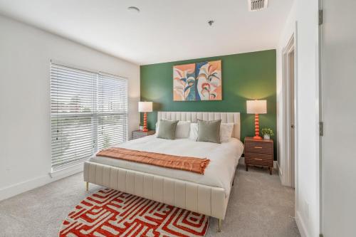 a bedroom with a large bed and a green wall at Reynoldstown Lux 2BR, Rooftop Deck, Near Beltline & Downtown, Free Parking in Atlanta