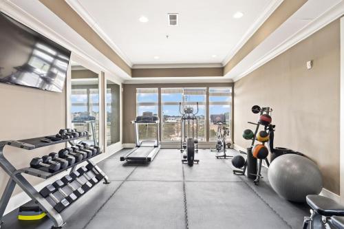 a gym with cardio equipment and a large window at Reynoldstown Lux 2BR, Rooftop Deck, Near Beltline & Downtown, Free Parking in Atlanta