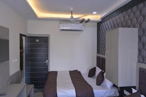 a bedroom with a bed in a room with a sink at hotel k stay by Anmol in Haridwār