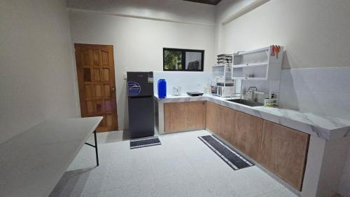 a kitchen with a counter top and a refrigerator at Casa Zavia in Sampong