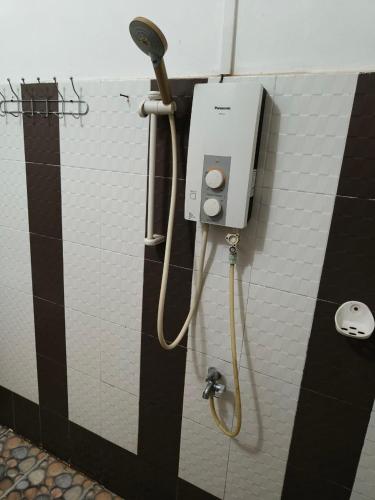 a shower in a public bathroom with a shower at NAMO ANGKOR VILLa in Siem Reap