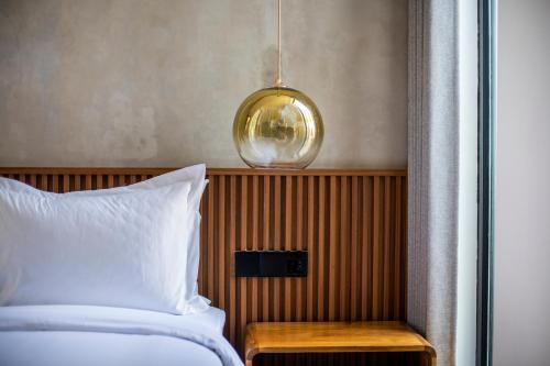 a bedroom with a bed and a pendant light at Jago Gili Air in Gili Islands
