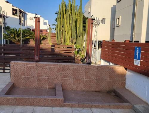 a park with wooden benches and a cactus at Hanapartment 3 bed Ayia NAPA in Ayia Napa