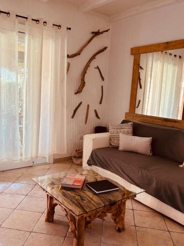 a living room with a couch and a coffee table at Isola Sarda Appart NICE in Murta Maria