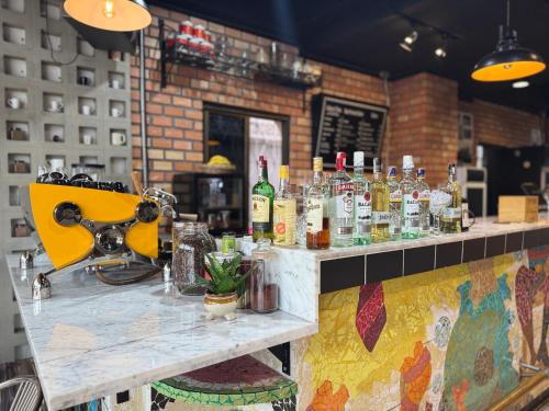 a bar with bottles of alcohol on a counter at Buakao Inn in Thongsala
