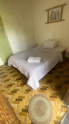 a bedroom with a bed with two towels on it at Alfarizi homestay in Tetebatu