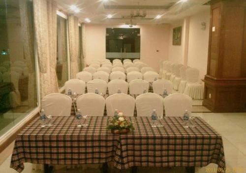a room with a table with white chairs and a set up at HOTEL STAR 39 in Ho Chi Minh City