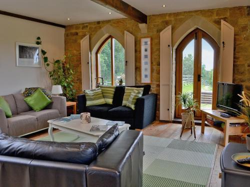 a living room with a couch and a table at The Water Castle in Wall Houses