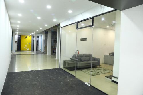 a living room with a couch in a building at Erica Hotel International in Perintalmanna