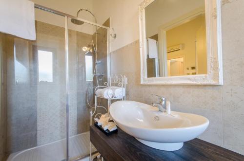 a bathroom with a sink and a shower at Agriturismo Tenuta Umberto I in Ripacorbaria