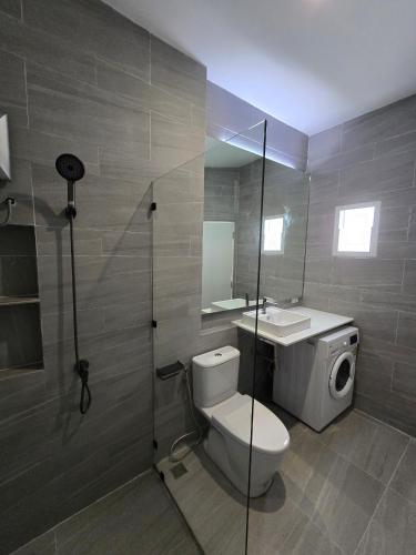 a bathroom with a toilet and a sink at Hommory Residence - East Chalong in Phuket